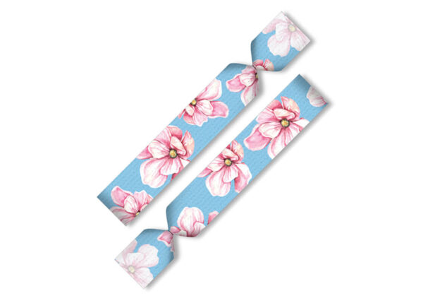 Elastic twistband hair tie and wristband with floral print on a blue background.