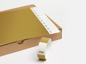 Sheet of gold Tyvek wristbands. Premium looking disposable bands for VIP access control. Manufacturer AMGS Group.