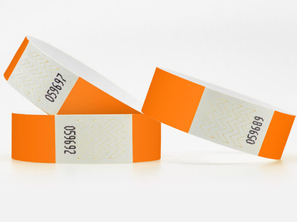 Orange Tyvek wristbands with printed serial numbers. Tamper-proof adhesive closure for security. Manufacturer AMGS Group.