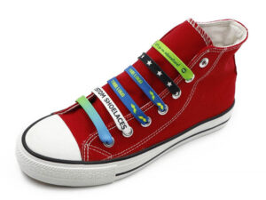 Red shoe with multicolor flat branded shoelaces with sublimation logos. From AMGS Group.
